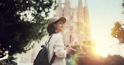 Frau mit einer Kamera vor der Sagrada Família in Barcelona, Spanien