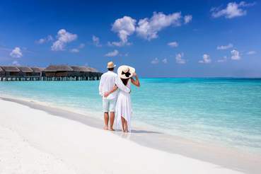 Paar am Strand beim Malediven Urlaub